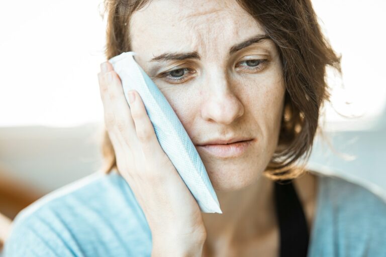 woman with toothache looking for home remedies for pain